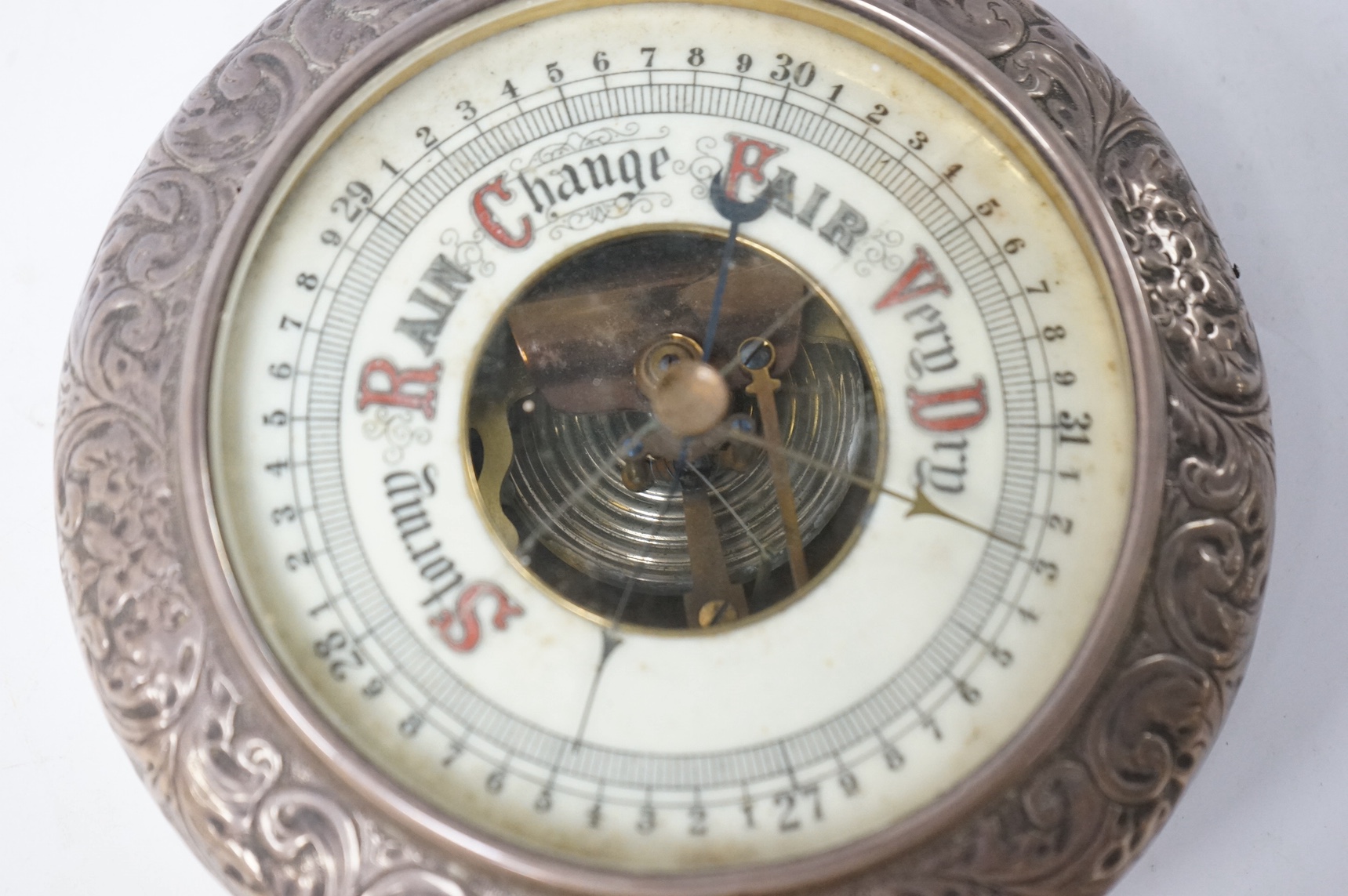 A late 19th/early 20th century silver mounted oak cased hanging barometer, marks rubbed, diameter 15.4cm. Condition - poor